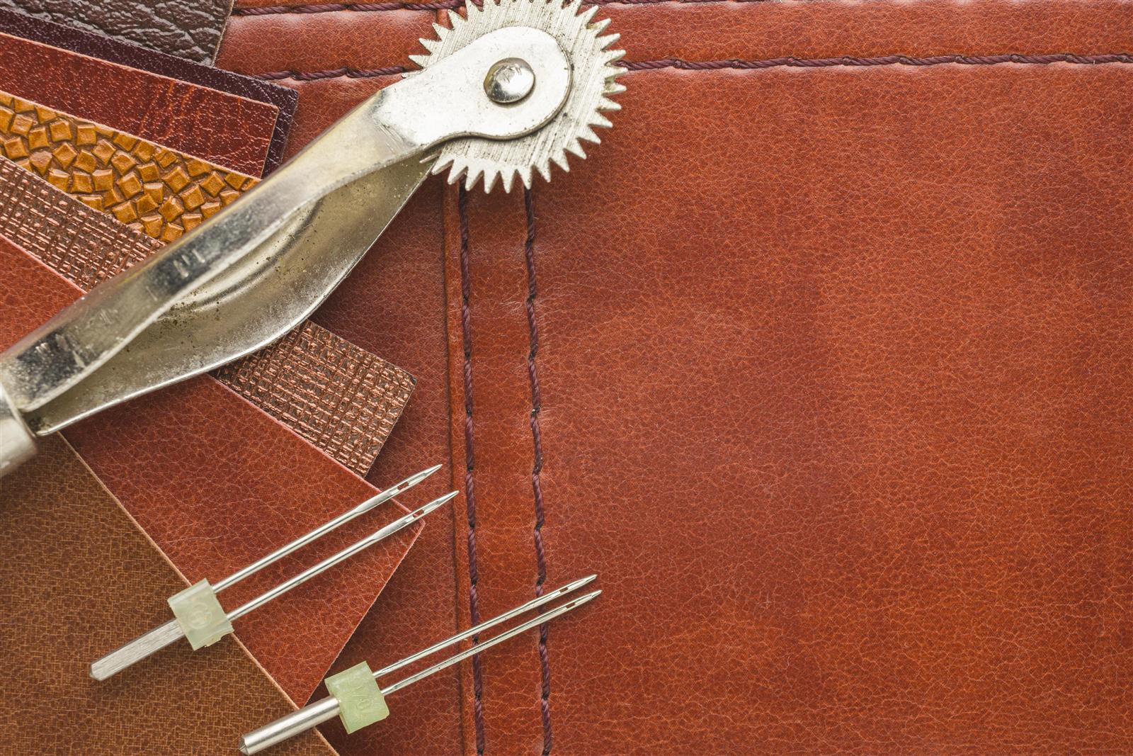Custom order — leather, needles and tools laid out on the bench